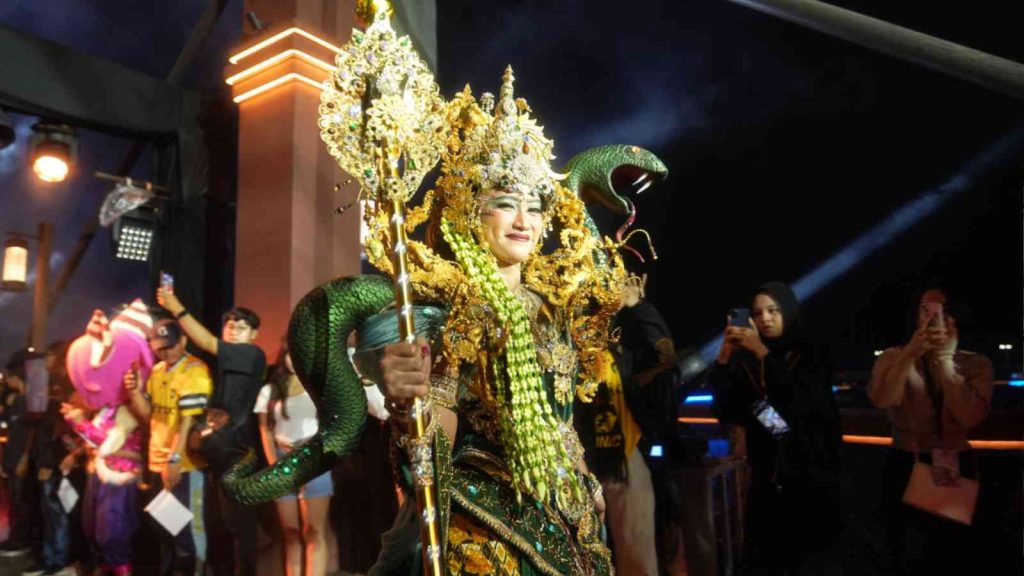 Female dancer in traditional attire with snake motifs at M7 Opening Ceremony in Jakarta, Indonesia