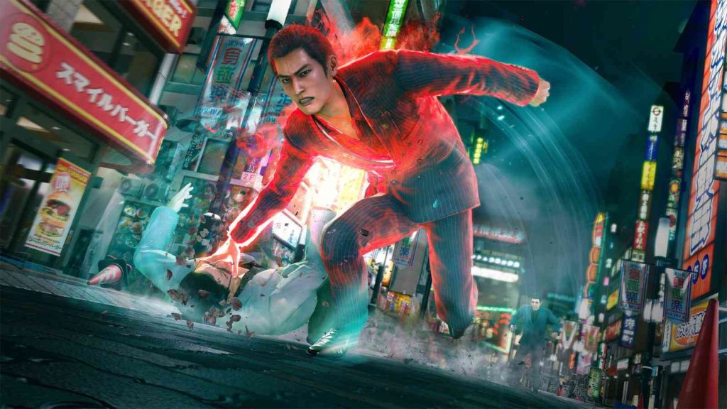 Kazuma Kiryu takes down an opponent on the city streets at night in Yakuza Kiwami 3